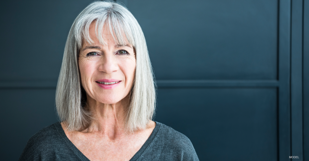 Middle-aged woman with gray hair smiling