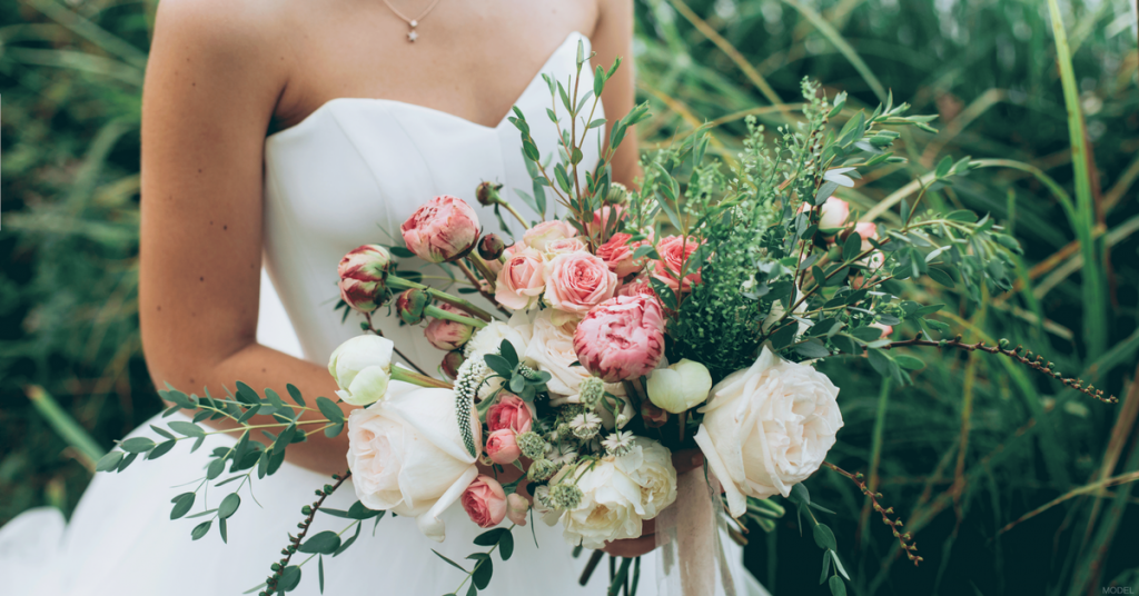 Woman outdoors with bouquet of flowers