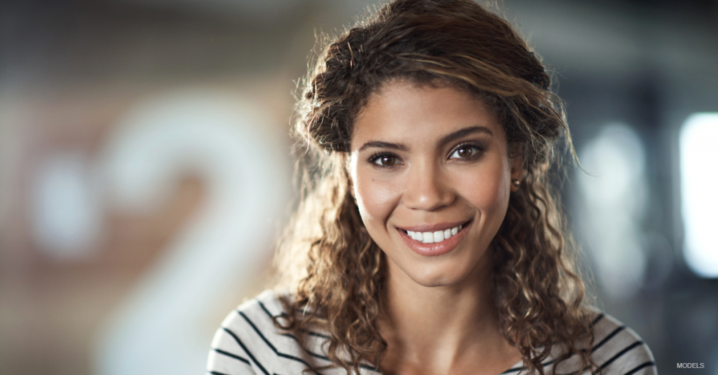 Young woman with brown hair smiling