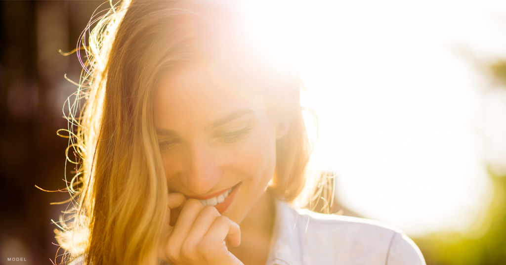 Young woman smiling outdoors