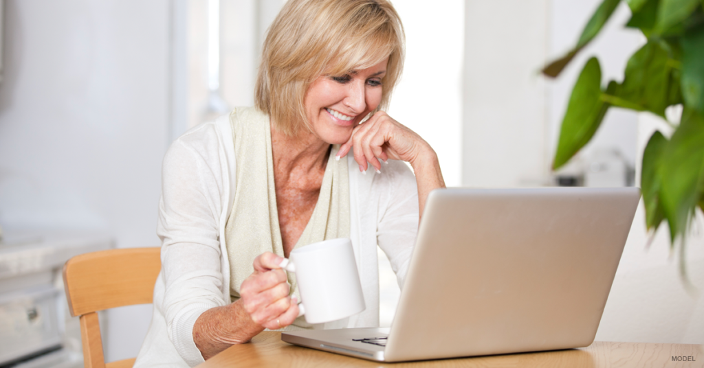 Middle-aged woman with laptop and coffee