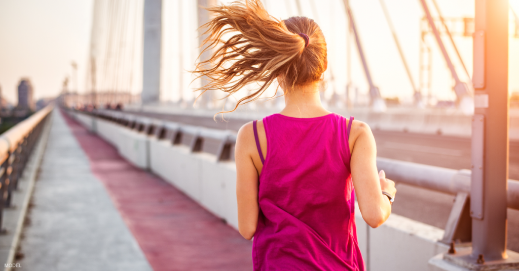 Woman jogging on bridge