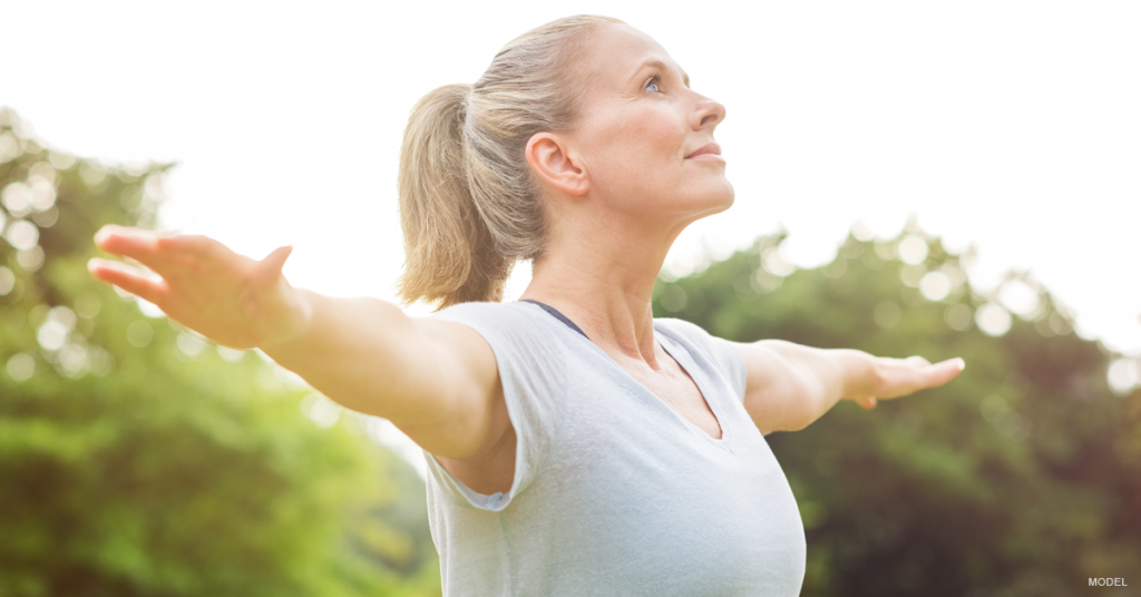 Woman outdoors with arms outstretched