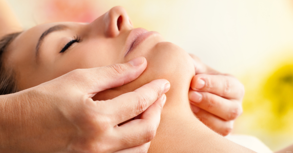 A woman's chin is touched at her facial surgery consultation.