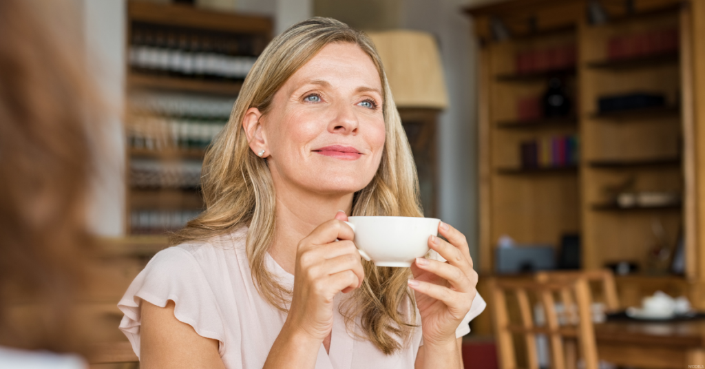 A woman gets coffee after getting a facial rejuvenation treatment.