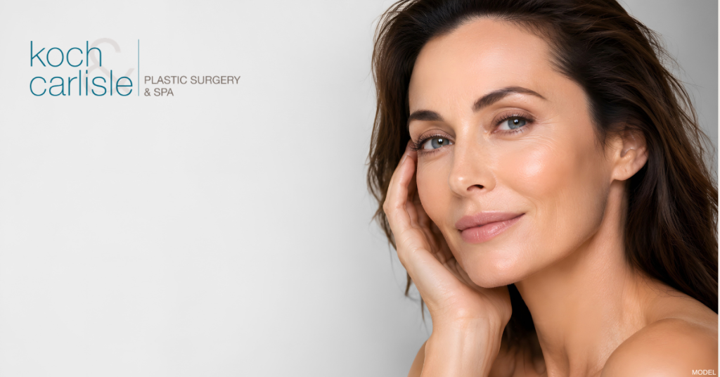 Woman gently touching her cheek with her hair swept back, beside the Koch & Carlisle Plastic Surgery & Spa logo.